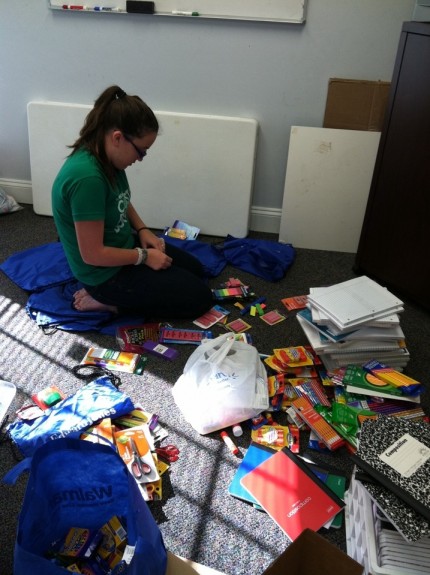 Katie collects and organizes the school supplies collected from her drive.